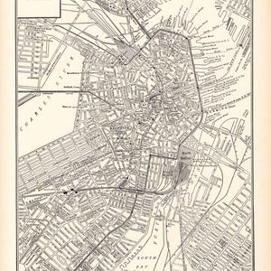 May include: A black and white map of Boston, Massachusetts. The map shows the city's streets, rivers, and landmarks. The text "Boston" is in the upper left corner of the map. The text "South Bay" is in the lower center of the map. The text "Charles River" is in the upper left corner of the map. The text "MAP OF BOSTON, CAPITAL OF MASSACHUSETTS. BOSTON IS THE SHOE AND LEATHER CENTER OF THE WORLD AND THE LARGEST WOOL MARKET IN THE UNITED STATES, AS WELL AS THE HUB OF HISTORIC INTEREST." is at the bottom of the map.
