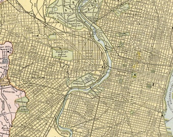 May include: A vintage map of Baltimore, Maryland, showing the city's streets and waterways. The map is in a light brown color scheme with some yellow and blue accents. The map includes the names of streets, parks, and other landmarks.