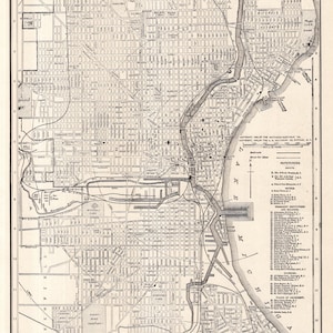 May include: A detailed black and white map of Milwaukee, Wisconsin, from the Gazetteer of Cities and Towns of the World. The map shows streets, parks, and the Milwaukee River. Text includes "Map of the City of Milwaukee, Wisconsin."