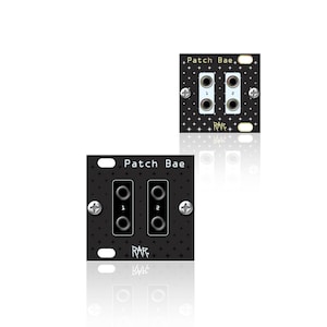 May include: Two black electronic modules with the text "Patch Bae" and the numbers "1" and "2" printed on them. The modules have a star pattern and are secured with silver screws. The word "RAR" is also visible.