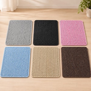 May include: A set of six rectangular mats featuring a raised honeycomb pattern. The mats are available in gray, black, pink, light blue, beige, and dark brown. Each mat has a uniform grid of small circular openings across the entire surface area.
