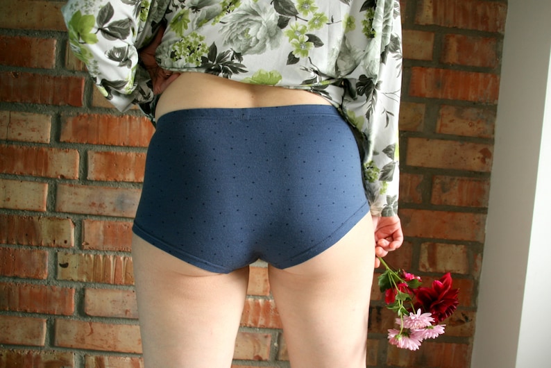 May include: A pair of blue polka dot underwear with a floral print shirt.