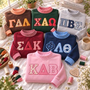 May include: Six crewneck sweatshirts in brown, dark green, light gray, maroon, navy blue, and pink, each featuring Greek letters with varied patterns like gingham, floral, and polka dots. The collars and cuffs are lined with matching gingham fabric.
