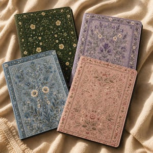 May include: Four rectangular tablet or e-reader cases featuring intricate floral patterns. The covers come in dark green, light purple, dusty blue, and muted pink, each bordered by a decorative frame and filled with detailed botanical illustrations.