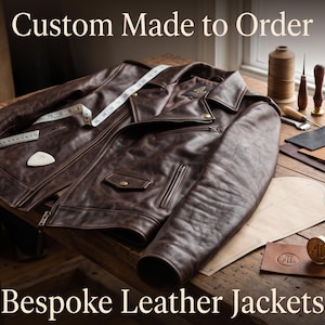 May include: A dark brown leather jacket with a notched collar, metal zippers, and snap buttons. The jacket is displayed with a white measuring tape, leather scraps, metal hardware, and a branding tool. Text reads: Custom Made to Order Bespoke Leather Jackets.