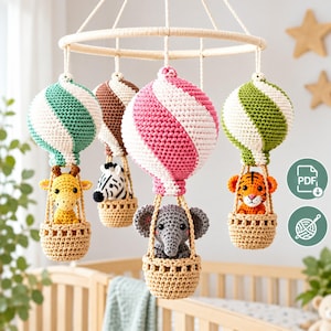 May include: A crochet nursery mobile featuring four hot air balloons with striped spheres in teal, brown, pink, and green. Each balloon basket carries a stuffed animal: a yellow giraffe, a black and white zebra, a gray elephant, and an orange tiger.