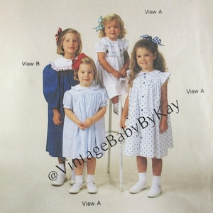 May include: A sewing pattern envelope titled The Children's Corner Patterns 11, Size 5-6, Bessie. The front shows four children wearing various dress styles labeled View A and View B, with a watermark reading VintageBabyByKay across the center.