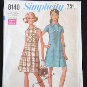 May include: Vintage Simplicity sewing pattern 8140 featuring two dress designs. One dress is a plaid print, the other is a solid blue with button details. The pattern includes Miss Petite sizing, bust 32.5 inches.