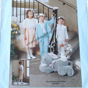 May include: A vintage sewing pattern titled "Eton Ensemble" featuring children's clothing. The pattern includes images of children in various outfits, including a light blue suit and a pink dress. The pattern is from Chery Williams Patterns, sizes 2-7.