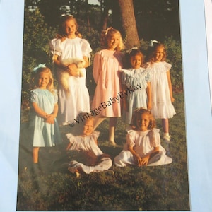 May include: A vintage sewing pattern titled "Basic Bishop" featuring a photo of several young girls wearing dresses. The dresses are in various pastel colors, including white, pink, and blue. The pattern is from Chery Williams Patterns.