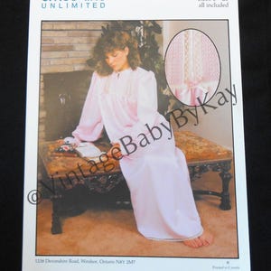 May include: A pattern for a smocked sleepshirt, sizes 6-20, is shown. The image features a woman wearing a long, light pink sleepshirt with long sleeves. The sleepshirt has a smocked bodice and a white trim. The pattern is from Smocking Unlimited.