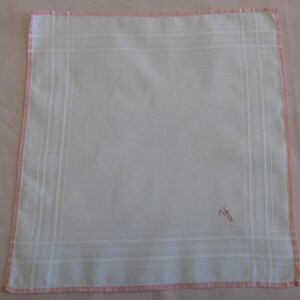 May include: White cotton handkerchief with a pink border and a pink embroidered initial "R" in the lower right corner.