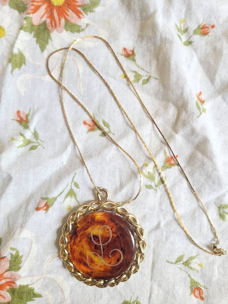 Vintage tortoise shell bakelite pendant with L monogram in a goldtone casing Free US shipping