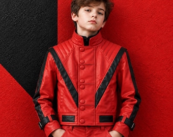 May include: A vibrant red leather jacket featuring bold black V-shaped panels across the chest and shoulders, a high collar, a central row of matching red buttons, and black buckled straps at the cuffs, paired with matching red leather trousers.