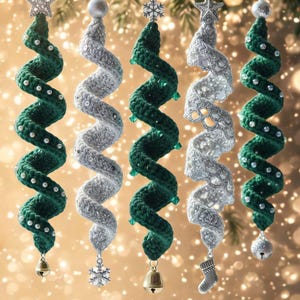 May include: Five hanging spiral ornaments in alternating dark green and silver colors. The green ornaments feature small white beads, while the silver ones have textured patterns. Each is topped with a star or snowflake and ends with a small bell or charm.