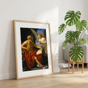 Peut inclure: Une impression d'art encadrée représentant une peinture classique d'un personnage âgé barbu drapé dans un tissu rouge, tenant un livre ouvert et portant des baskets modernes blanches, bleues et rouges. Un ange aux grandes ailes blanches se tient derrière.