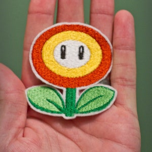 FIRE FLOWERChoose one Embroidered Iron-on Nintendo Throwback NES Mario Brothers. Indicate color in blue or orange. image 1