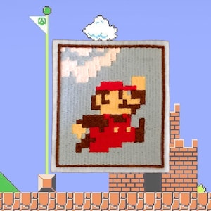 May include: A pixelated patch featuring Mario in his classic red outfit, jumping against a gray sky with a white cloud. The patch is framed with a white border, set against a blue background with a brick platform and a flag.