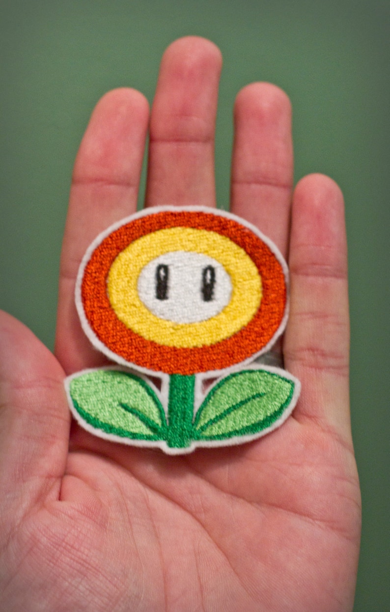 FIRE FLOWERChoose one Embroidered Iron-on Nintendo Throwback NES Mario Brothers. Indicate color in blue or orange. image 1