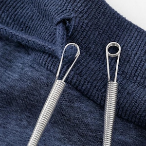 May include: Two silver-colored metal tools with coiled handles and looped tips. One tool features a simple elongated wire loop at the end, while the other tool has a small circular wire loop at the tip, set against a dark blue fabric background.