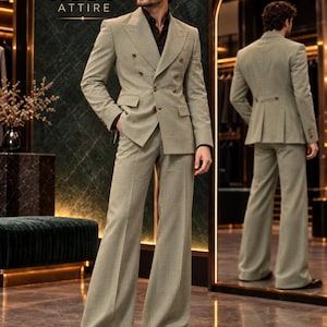 May include: A light green double-breasted suit with a dark brown shirt. The jacket features wide lapels and brown buttons. The trousers have a wide-leg cut. The text RUBY ATTIRE is visible in the upper left corner of the image.