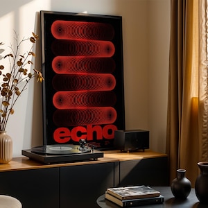 May include: A framed vertical poster featuring a black background with five horizontal rows of red concentric circles and the word echo in red at the bottom. The poster is displayed on a wooden surface next to a black record player and a speaker.