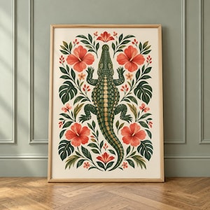 Pode incluir: Uma impressão de arte de parede retangular vertical apresentando uma ilustração central de um crocodilo verde cercada por arranjos simétricos de grandes flores de hibisco vermelhas e folhas tropicais verde-escuras em um fundo creme.