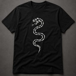 May include: A black short-sleeved t-shirt featuring a white graphic print of a coiled snake in the centre. The snake design is rendered in a stylised, skeletal, or geometric line art pattern with its mouth open and tongue extended outwards.