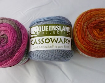 May include: Three skeins of yarn in different color combinations. The yarn is labeled "Queensland Collection Cassowary Colorful Australian Fine Wool Blend."
