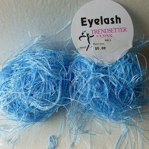 May include: Two skeins of light blue eyelash yarn, labeled "Eyelash" and "Trendsetter Yarns" with a price of $5.00.