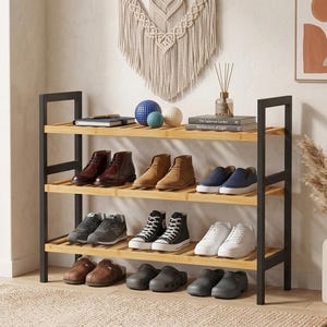 May include: A three-tier shoe rack featuring a light brown bamboo slatted frame and a sturdy black metal structure. The shelves are organized with various styles of footwear, including boots, sneakers, and slip-on shoes, arranged in neat rows.