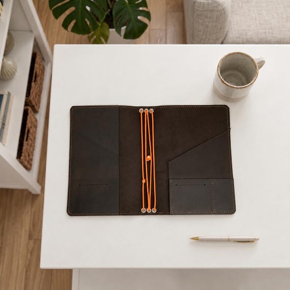 A refillable, multi-size leather traveler's notebook cover with monogramming — genuinely crafted, modular, and gets better with age.