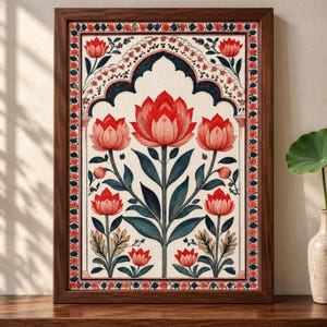 May include: A framed wall art print featuring a symmetrical floral illustration with large red lotus flowers and dark green leaves set within an arched architectural border. The design includes a decorative outer frame of small red flower motifs.
