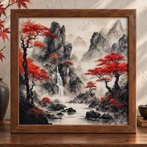 May include: A square cross-stitch embroidery in a dark wooden frame depicting a landscape with black and gray mountains, a central waterfall, and vibrant red trees. The scene features rocky terrain, a flowing stream, and small birds in the sky.