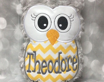 May include: A gray and white plush owl with yellow chevron fabric and the name "Theodore" embroidered on the front.