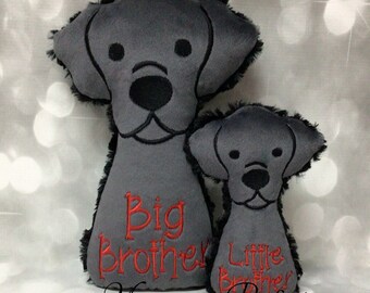 May include: Two gray plush dog pillows with black embroidered faces. The larger pillow says "Big Brother" and the smaller pillow says "Little Brother".
