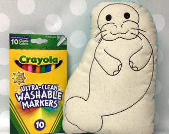 May include: A plush seal-shaped pillow with black outline details and a box of Crayola Ultra-Clean Washable Markers. The marker box is yellow with a green top and contains 10 classic colors. The text "Monogram Perfect" is at the bottom.