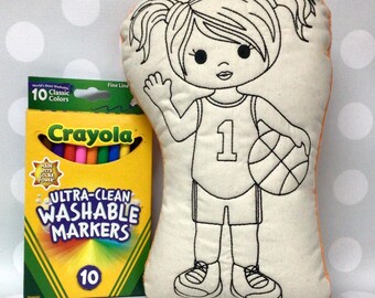 May include: A fabric doll in the shape of a basketball player, with a number 1 jersey, holding a basketball. Next to it is a box of 10 Crayola Ultra-Clean Washable Markers. The doll is a coloring project. The text "Monogram Perfect" is at the bottom.