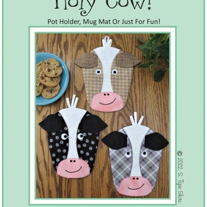May include: Three cow-shaped pot holders or mug mats with different patterned faces: houndstooth, polka dots, and plaid. Each has a pink mouth, white nose stripe, and black or brown ears. The text "Holy Cow!" and "Pot Holder, Mug Mat Or Just For Fun!" are visible.