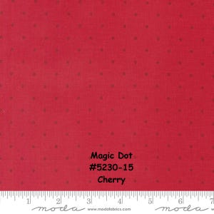 May include: A close-up of red fabric with small, evenly spaced brown dots. The fabric has the text "Magic Dot #5230-15 Cherry" printed on it. A ruler is at the bottom of the image.