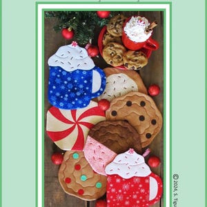 May include: Set of six quilted mug rugs and pot holders featuring a Christmas theme. The designs include a red and white candy cane, a gingerbread cookie, a chocolate chip cookie, and three mugs of hot chocolate with whipped cream and sprinkles. The text "Cookies & Cocoa For Santa!" is printed on the image.