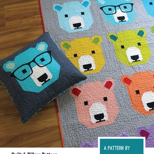 May include: A quilt and pillow pattern with a repeating pattern of bear faces in shades of blue, yellow, pink, and orange. Some bears wear glasses. The pattern includes instructions for a 50 cm x 50 cm pillow cover. The text "BJORN BEAR" is at the top.