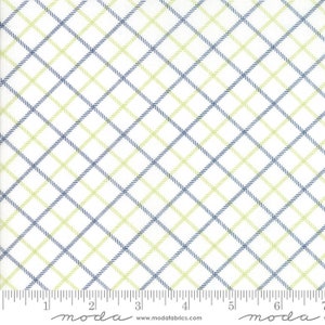 May include: White fabric with a blue and green plaid pattern. The fabric is measured in inches with the text "moda" printed on the ruler.