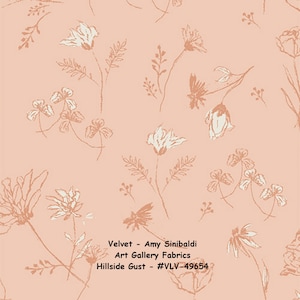 May include: A peach-colored fabric with a white floral pattern. The fabric is called "Hillside Gust" and is a velvet fabric from Art Gallery Fabrics by Amy Sinibaldi. The fabric is #VLV-49654.