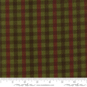 May include: Green and red plaid fabric with a subtle texture. The fabric is measured in inches with a ruler that says "moda" at the beginning and end of the ruler.