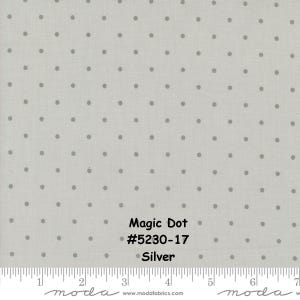 May include: A silver fabric with a white background and small grey polka dots. The fabric has the text "Magic Dot #5230-17 Silver" printed on it.