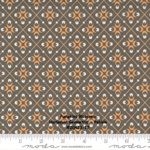 May include: A brown fabric with a repeating pattern of orange crescent moons, white dots, and thin white lines forming a grid. The fabric has the text "Pumpkins Blossoms Harlequin Geometric - Pebble #20423-17" printed on it.