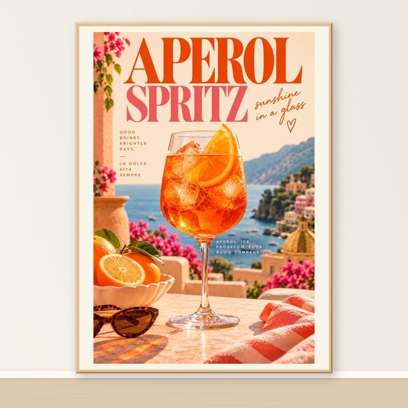 Aperol Spritz wall art print of an orange cocktail overlooking a Mediterranean coastline with retro typography and sunset tones