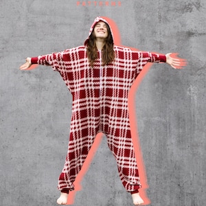 May include: A red and white plaid hooded jumpsuit with long sleeves and cuffed ankles. The garment features a front zipper closure and a hood. The text "Rivet PATTERNS" appears at the top, and "Designed for Knit Fabric" is at the bottom.