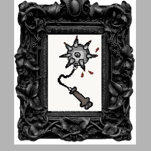 May include: A pixel art illustration of a grey spiked flail weapon with a central eye, attached to a brown handle by a black chain, displayed inside an ornate, matte black rectangular frame featuring detailed leaf and berry carvings.